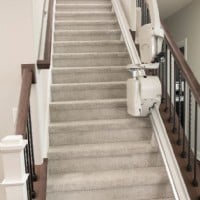 New Bruno Elan stairlift with components folded up at middle of staircase