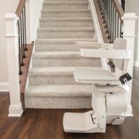 up close view of new Bruno Elan stairlift at bottom landing of staircase