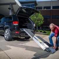 Man Setting Up Portable Folding Ramp, Trifold