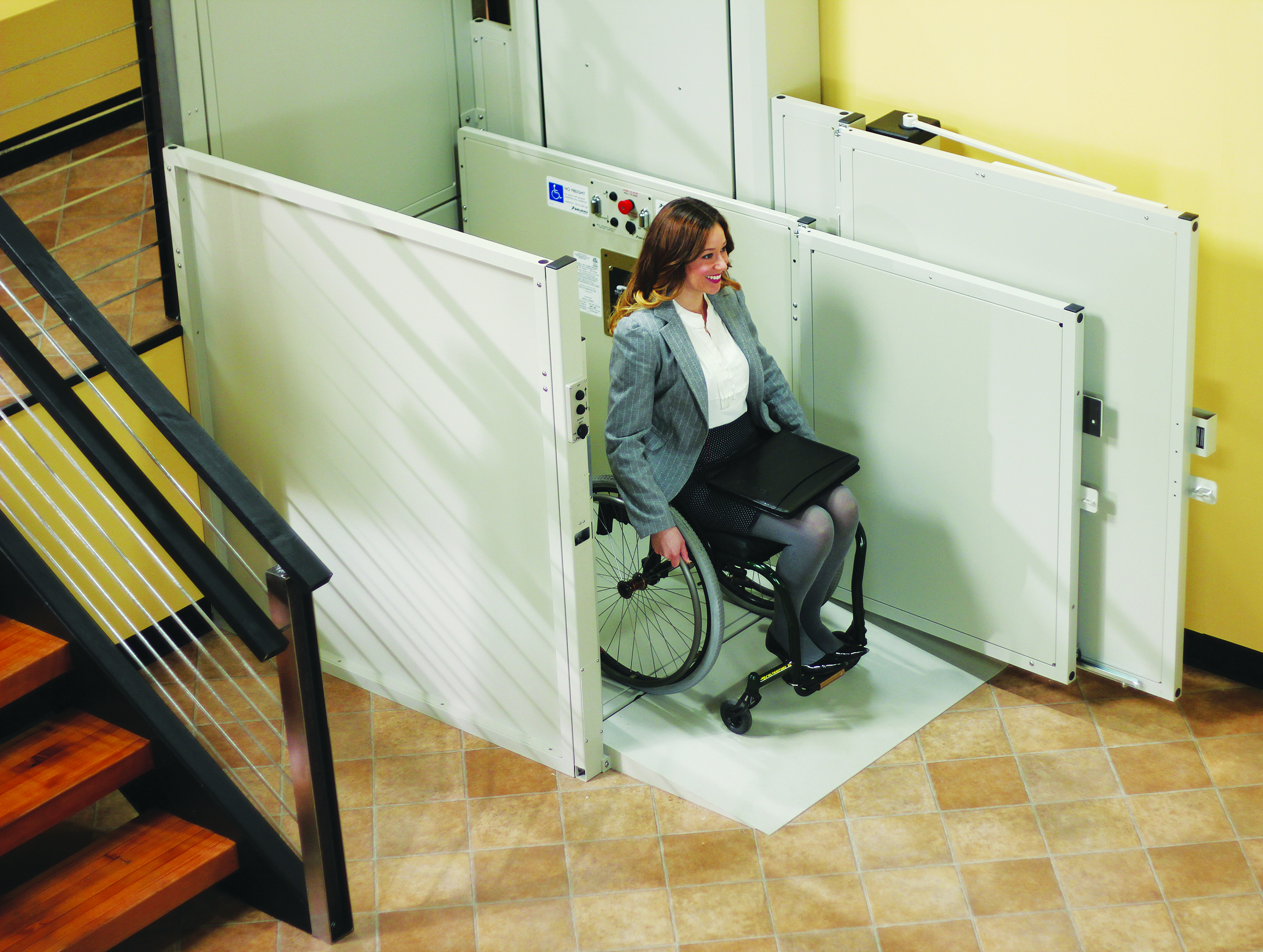 woman in wheelchair exiting Bruno commercial wheelchair lift