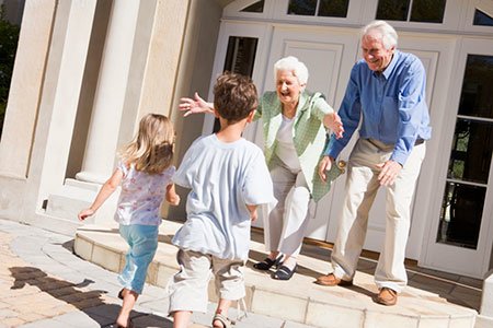 happy grandparents welcome grandchildren to their home