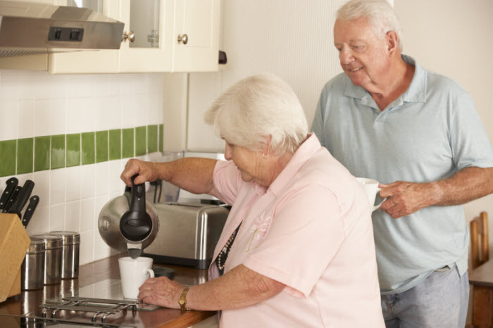 woman pouring coffee in kitchen