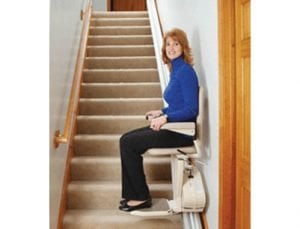 young woman riding stairlift